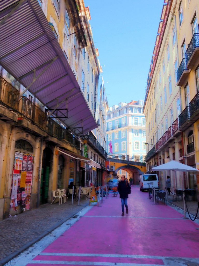 Women walking through the pink street in Lisbon, Portugal
