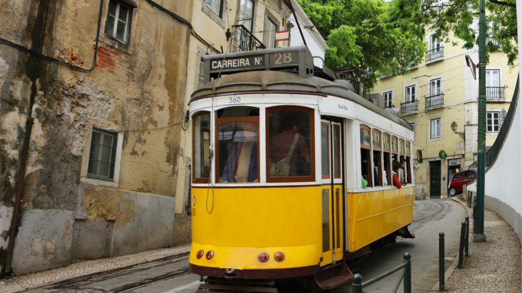 Yellow tram 28 in the streets of Alfama, Lisbon