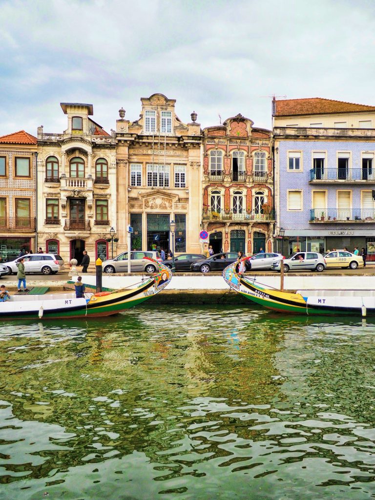 The main canal of Aveiro with some Moliceiros or traditional boats and Rococco buildings on the backdrop, Portugal