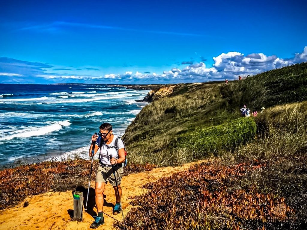 A woman is hiking the Costa da Vicentina trail in Portugal